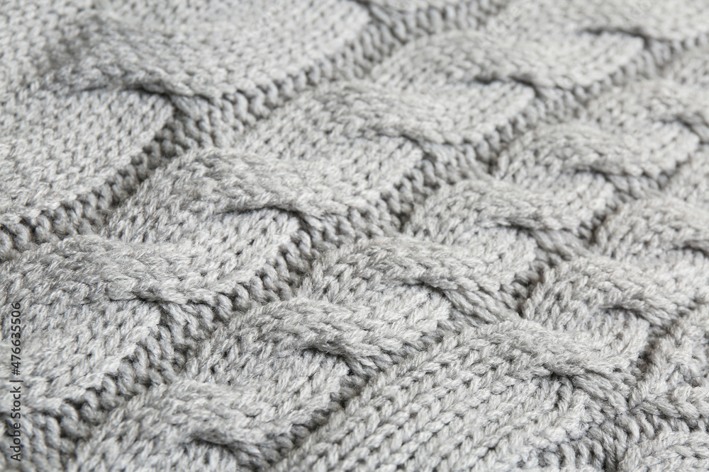 Grey knitted fabric with beautiful pattern as background, closeup Grey knitted fabric with beautiful pattern as background, closeup