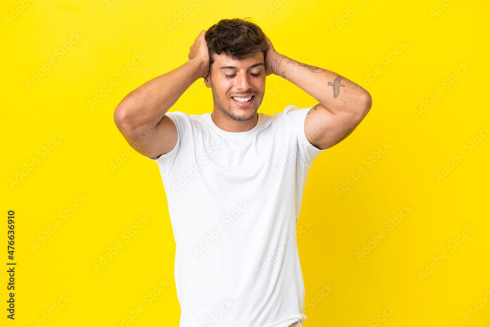 Young caucasian handsome man isolated on yellow background laughing Young caucasian handsome man isolated on yellow background laughing