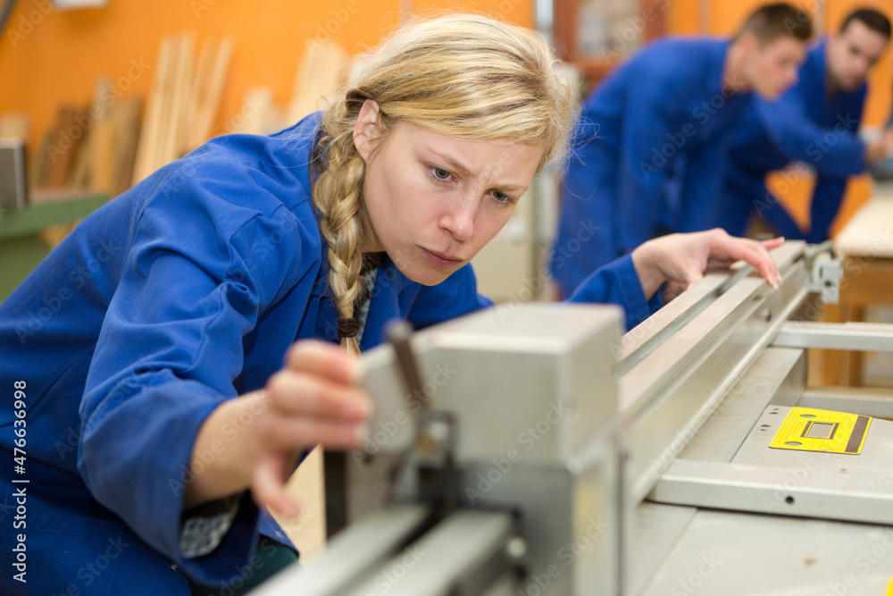 woman as apprentice for carpentry learning and working
