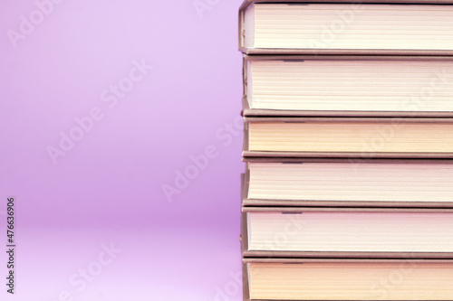 Stack of books on pink background. Study  education and back to school concept. Close up copy space image.