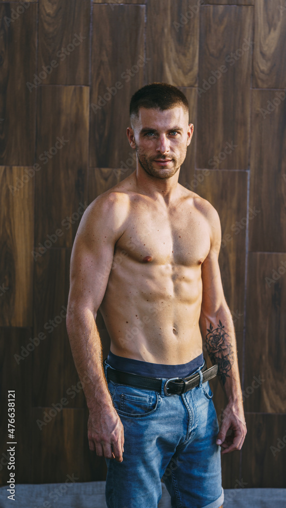 fit male model posing without shirt