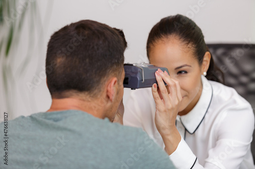 woman doing eye test with optometrist in eye sight clinic