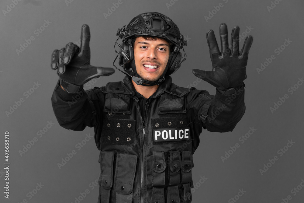 SWAT caucasian man isolated on grey background counting seven with fingers SWAT caucasian man isolated on grey background counting seven with fingers