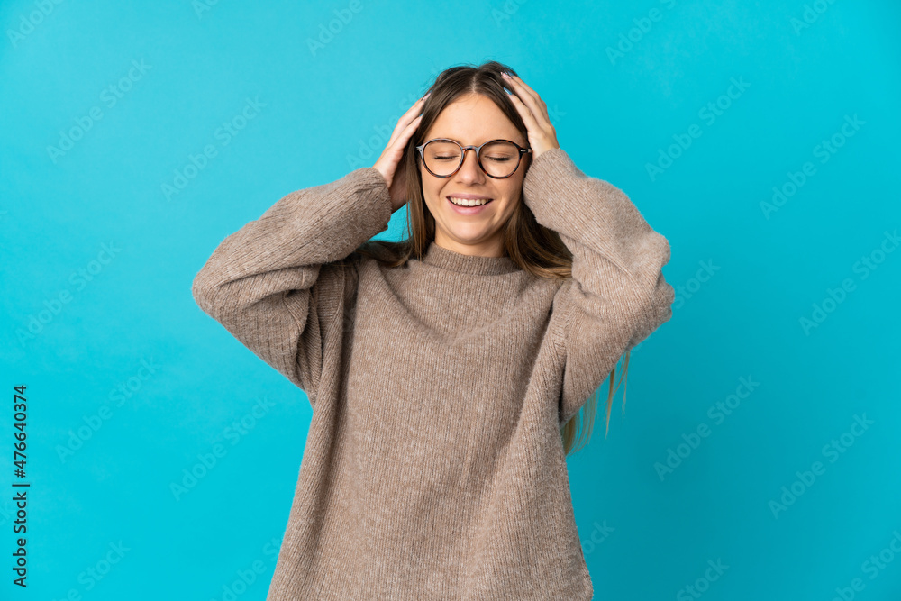 Young Lithuanian woman isolated on blue background laughing Young Lithuanian woman isolated on blue background laughing