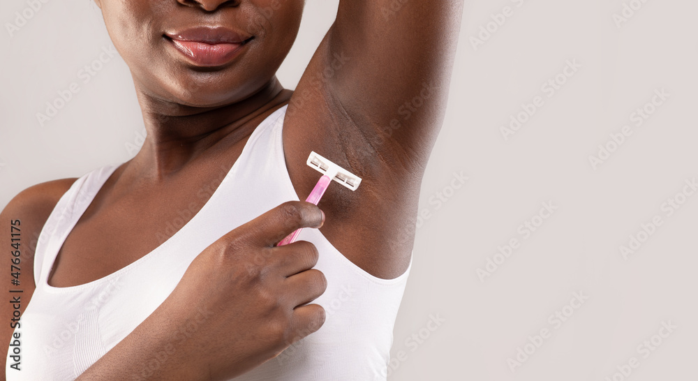 Closeup Of Unrecognizable African American Lady Shaving Underarm With Pink Razor Closeup Of Unrecognizable African American Lady Shaving Underarm With Pink Razor