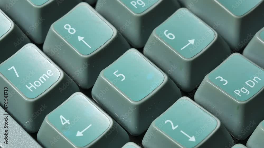 Anonymous man using the numpad on a desktop PC keyboard, hand up close, finger pressing number keys, calculating macro, object detail extreme closeup. Office job, business calculation abstract concept Anonymous man using the numpad on a desktop PC keyboard, hand up close, finger pressing number keys, calculating macro, object detail extreme closeup. Office job, business calculation abstract concept