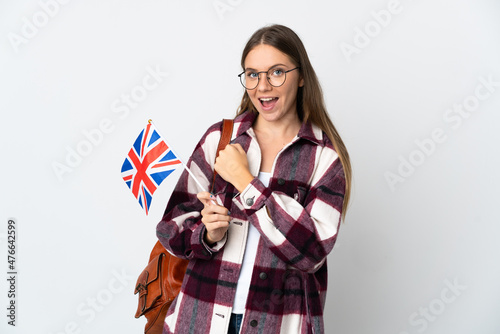 Young Lithuanian woman holding an United Kingdom flag isolated on white background celebrating a victory