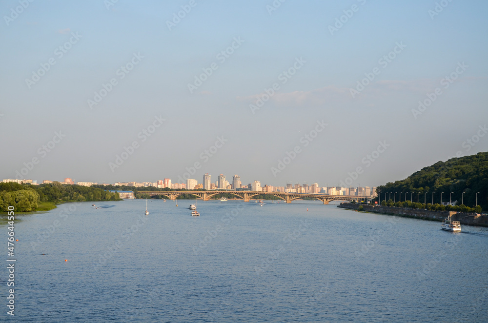 Beautiful summer view to the Dnipro river and right and left banks, bridge and Residential buildings on background. Kyiv, Ukraine