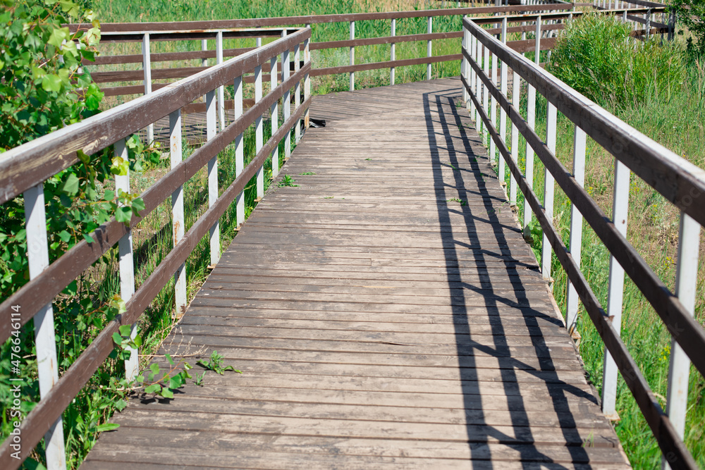 Wooden bridge with railings in summer Wooden bridge with railings in summer