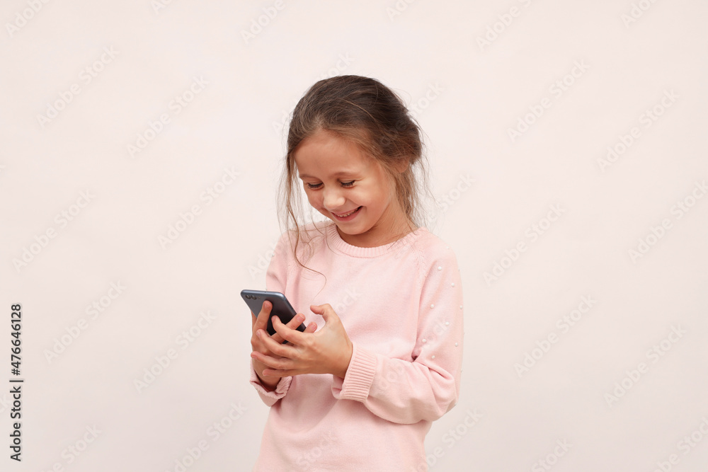 Female child using smart phone on white background Female child using smart phone on white background
