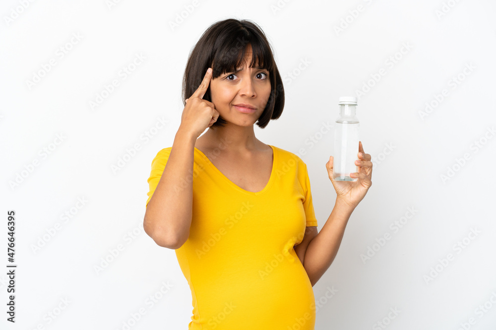 Young pregnant woman holding a bottle of water isolated on white background thinking an idea Young pregnant woman holding a bottle of water isolated on white background thinking an idea