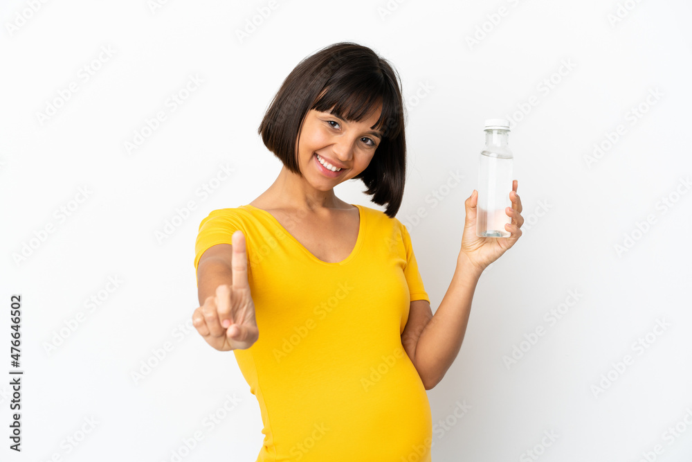 Young pregnant woman holding a bottle of water isolated on white background showing and lifting a finger Young pregnant woman holding a bottle of water isolated on white background showing and lifting a finger