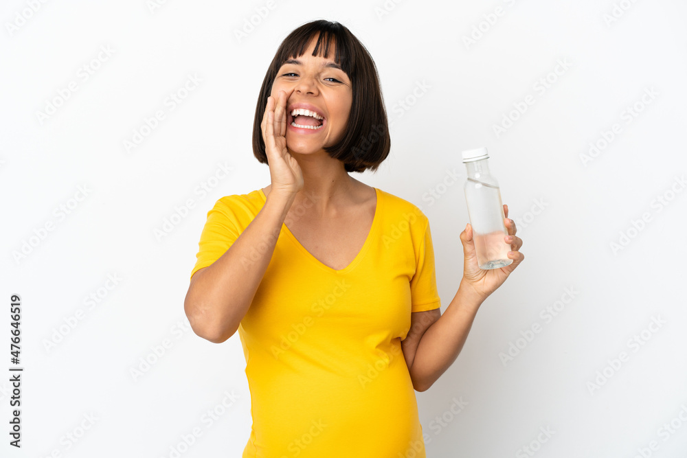 Young pregnant woman holding a bottle of water isolated on white background shouting with mouth wide open Young pregnant woman holding a bottle of water isolated on white background shouting with mouth wide open