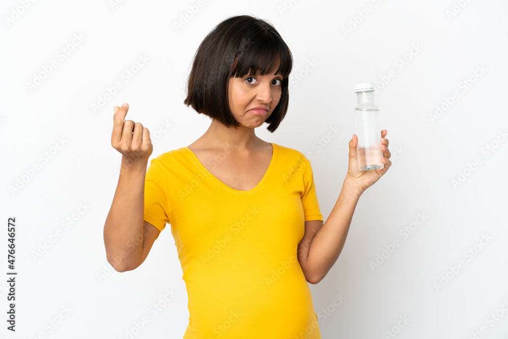 Young pregnant woman holding a bottle of water isolated on white background making money gesture Young pregnant woman holding a bottle of water isolated on white background making money gesture