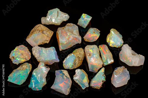 macro mineral stone rare and beautiful opals on a black background