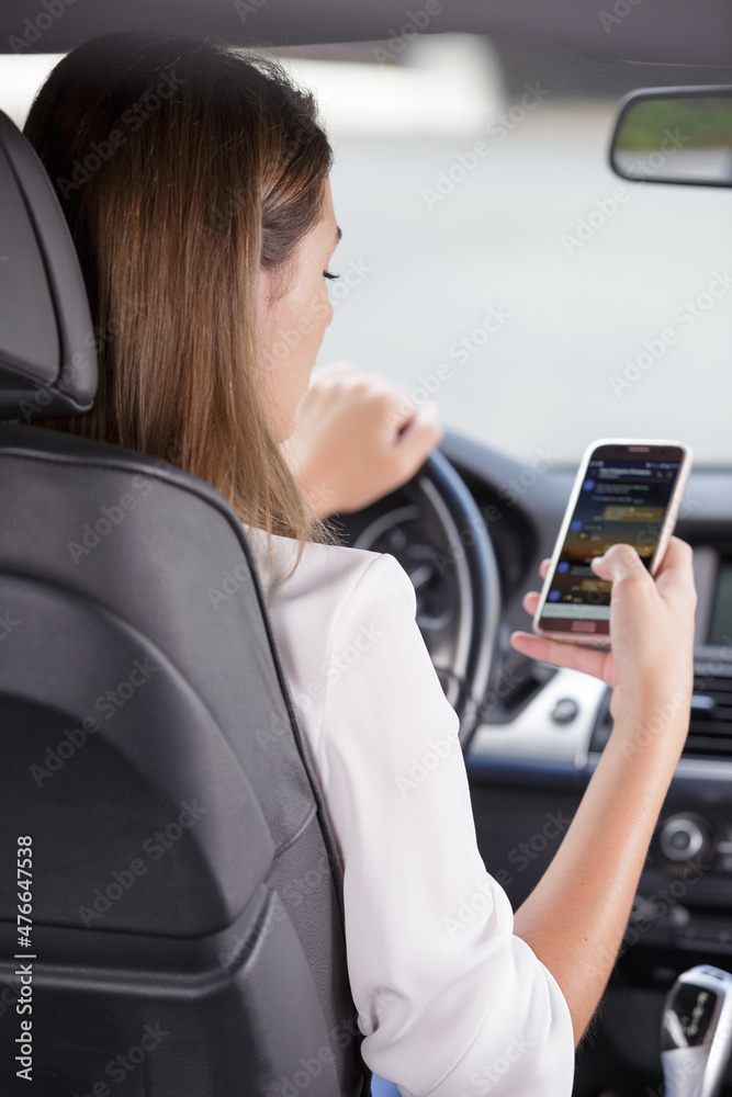 woman unlawfully sending message on smartphone while driving