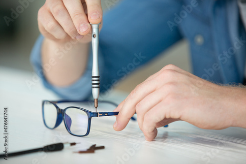 optician repairing and fixing eye glasses