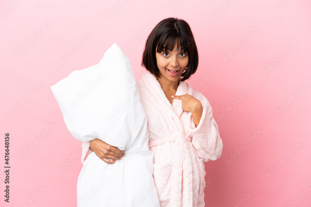 Pregnant woman in pajamas isolated on pink background with surprise facial expression Pregnant woman in pajamas isolated on pink background with surprise facial expression