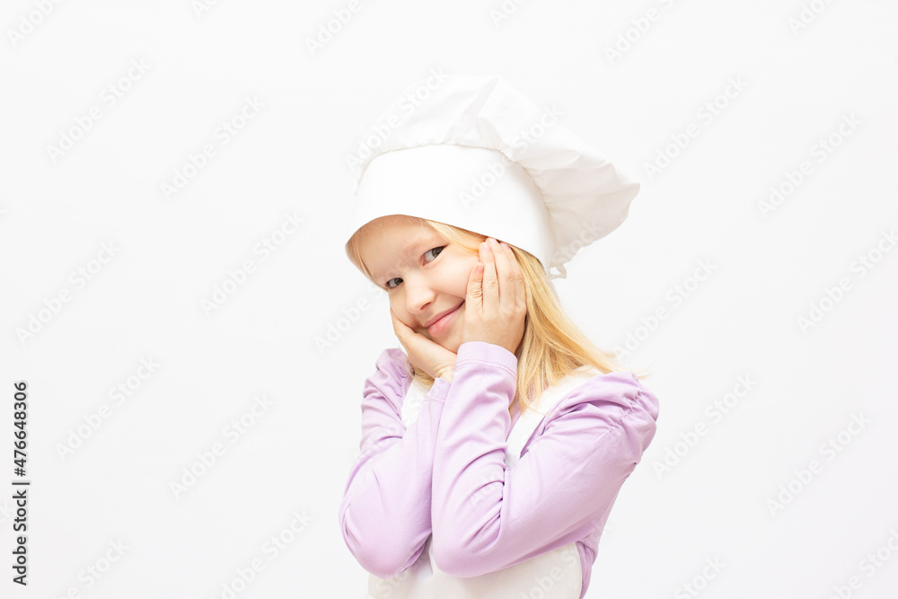 Beautiful little girl in chef uniform isolated on white Beautiful little girl in chef uniform isolated on white