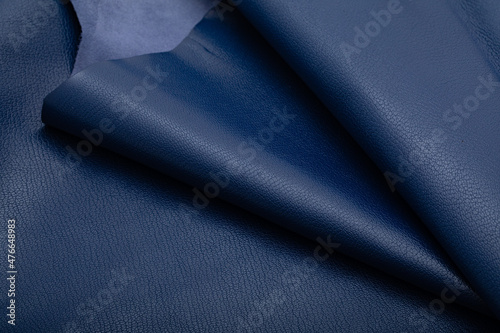 dark blue folded natural cow leather on the wooden table 