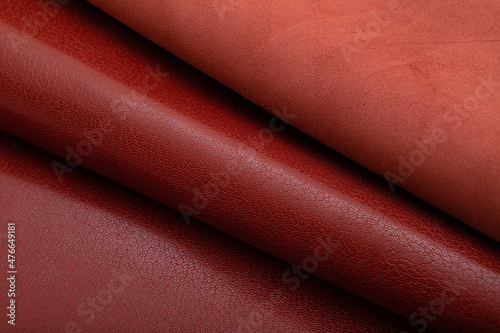 Brown glossy folded natural cow leather on the wooden table 