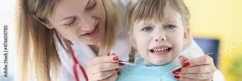 Little girl is afraid of dentist doctor closeup
