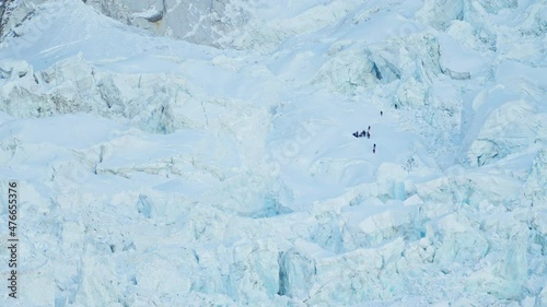Awesome panorama. Alpinists group ascending across huge grand snow white glacier