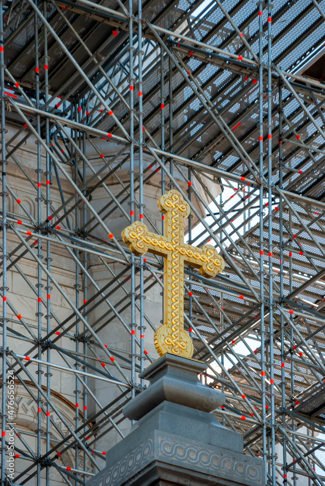 Cross of the Cathedral of Christ the Savior against the background of scaffolding