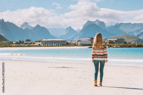 Travel in Norway tourist woman  walking on sandy beach enjoying mountains view alone outdoor active vacations adventure lifestyle solo trip © EVERST