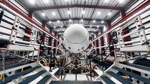 Space launch preparation. Spaceship SpaceX Crew Dragon, atop the Falcon 9 rocket, inside the hangar , just before rollout to the launchpad. Elements of this image furnished by NASA
