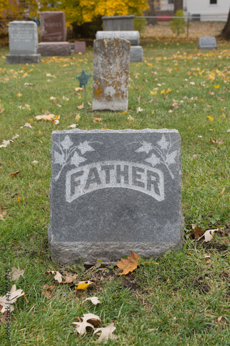 Gravestone that simply says "FATHER" with no other identification; ivy carved into stone as decoration