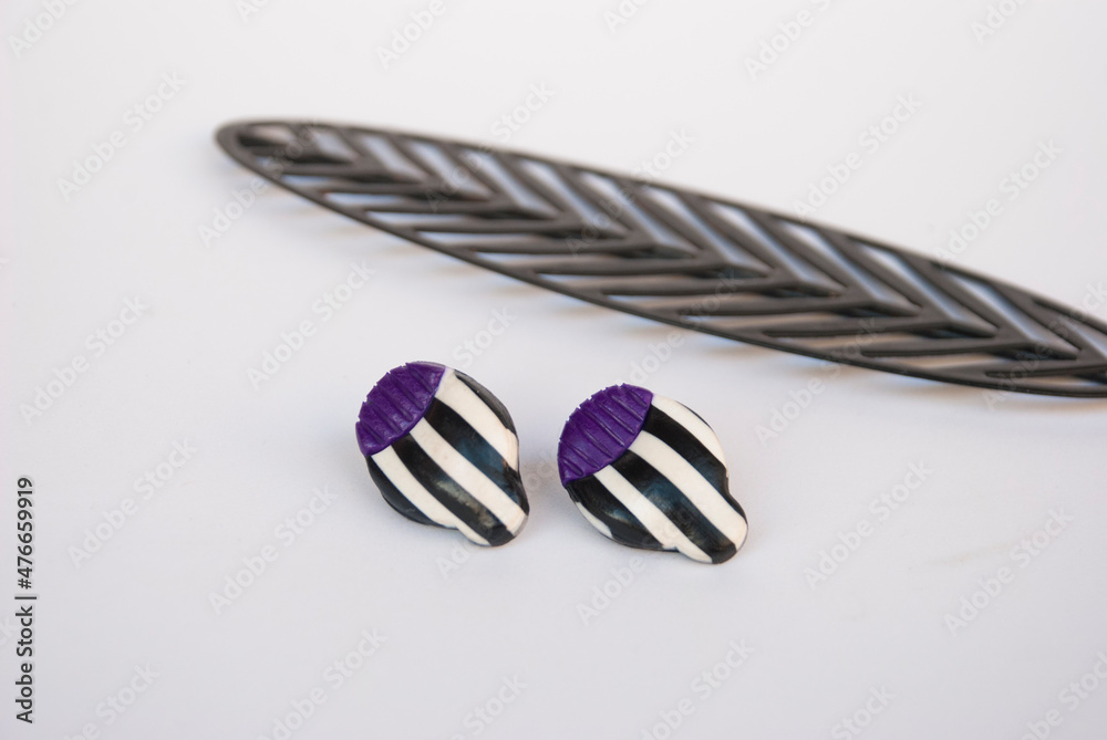 Naklejka premium Geometric striped flower studs of polymer clay. Handmade earrings.