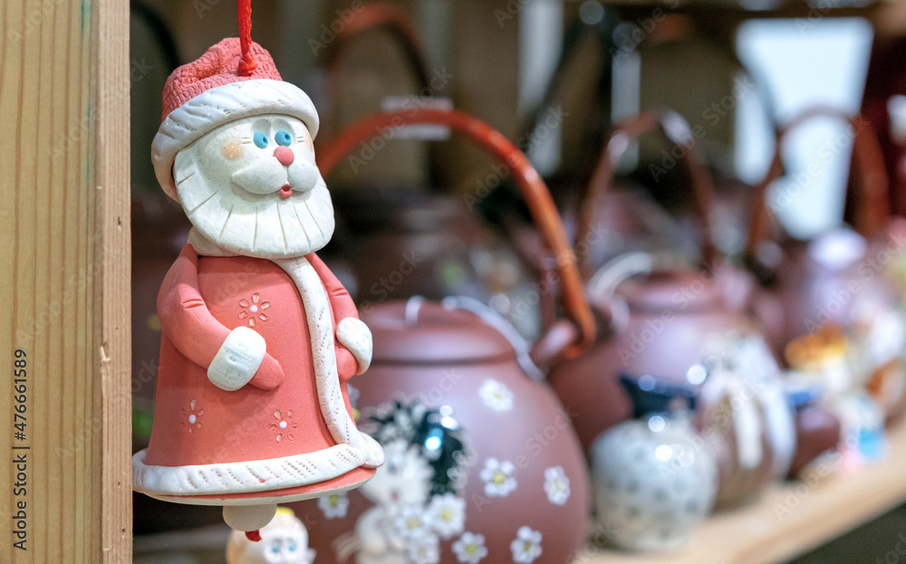 Ceramic figurine of Santa Claus or Father Frost in a red fur coat.