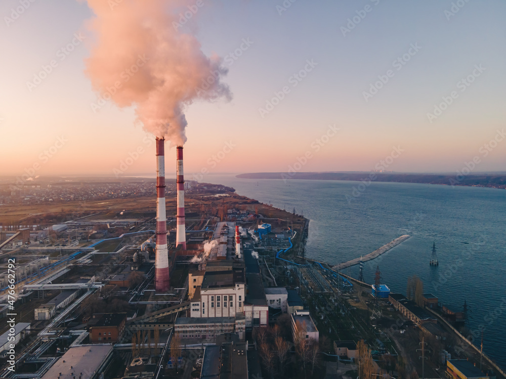 Industrial factory smokestack emission carbon gases and in atmosphere. Industry zone, factory smoke plumes. Climate change, ecology and global warming