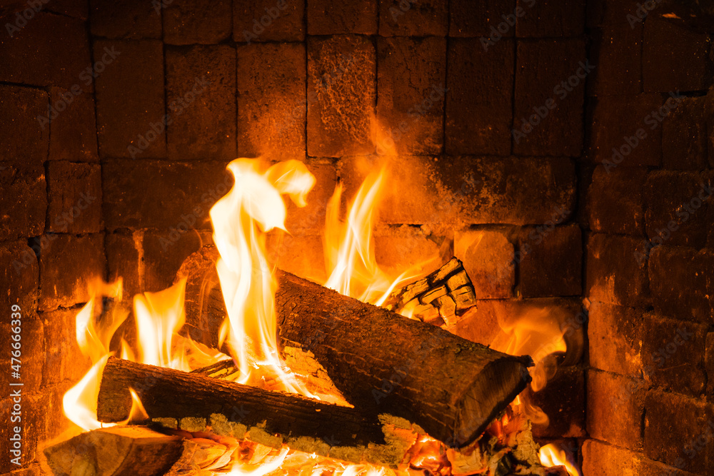 Glowing fire in home stone fireplace Stock Photo | Adobe Stock
