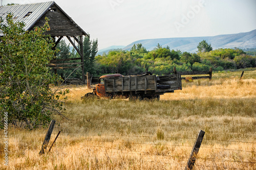 Abandoned truck in grassy field 