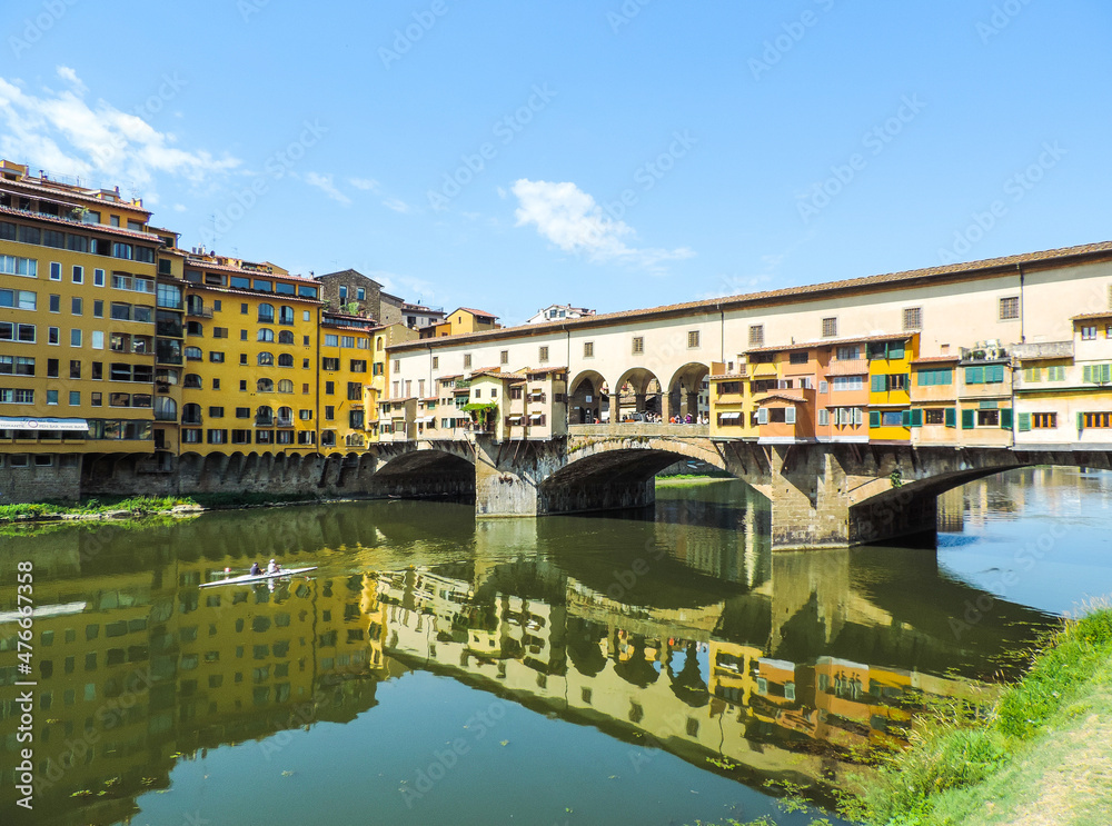 view of Ponte Vecchio reflected in the waters of arno river - Florence, Italy