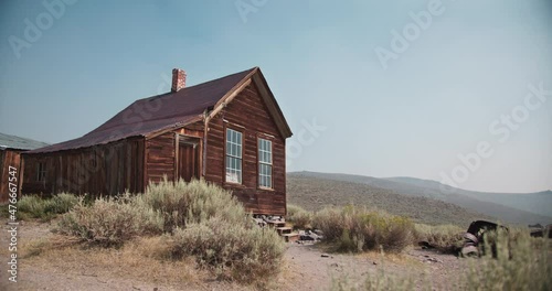 Rustic historic wooden home in the hills of the gold rush mining area in western America photo