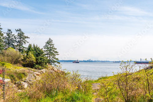 Ocean view with mountains, blue sky and white clouds in slow motion at summer day in Vancouver, Canada, North America. Day time on September 2021.