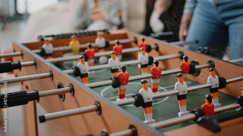 Bild auf Leinwand Close up of colleagues playing at foosball table after work