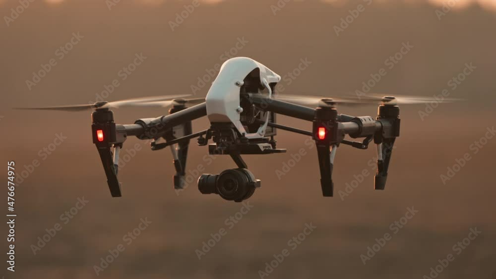 Closeup smart professional aircraft quadcopter drone analyzing farming fields flying above landscape. Modern technologies. Agribusiness innovation.