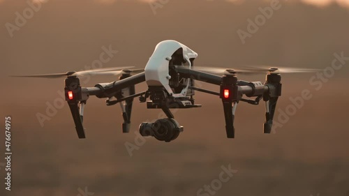 Closeup smart professional aircraft quadcopter drone analyzing farming fields flying above landscape. Modern technologies. Agribusiness innovation. photo