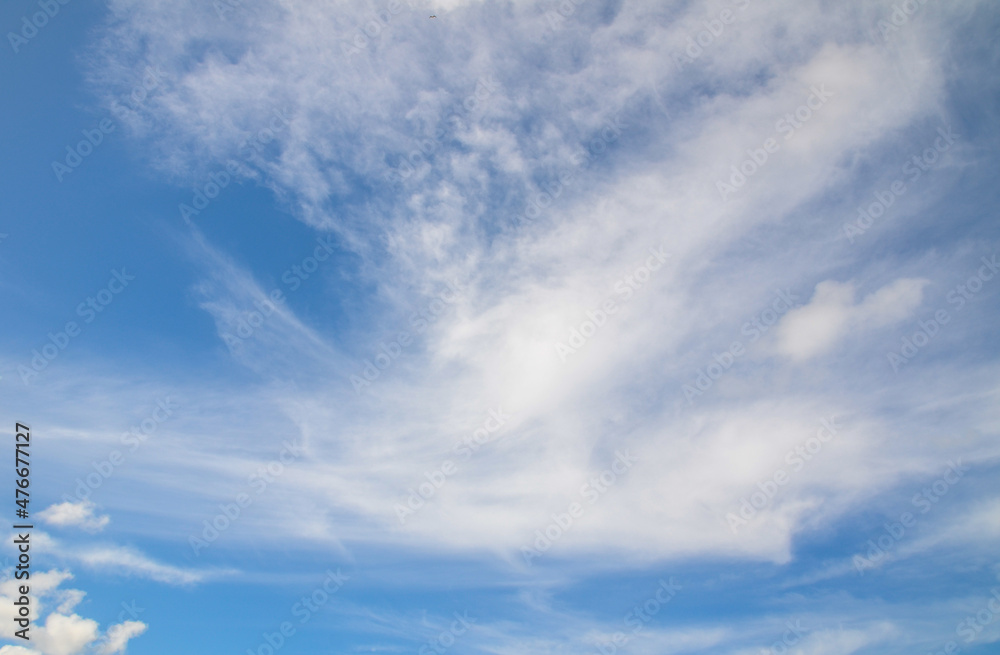 Slightly clouds on the blue sky showing white soft texture pattern.