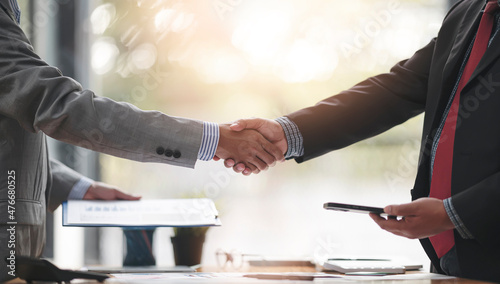 Negotiating business,Image of businessmen Handshaking,happy with work, Handshake Gesturing People Connection Deal Concept. Cropped image.
