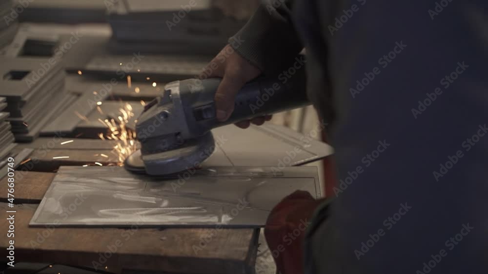 Close up of worker using grinder over piece of metal in factory production line. Slow motion. Close up of worker using grinder over piece of metal in factory production line. Slow motion.