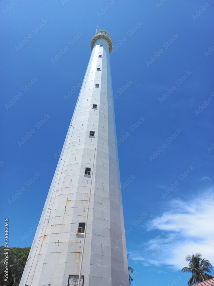 Lighthouse below blue sky