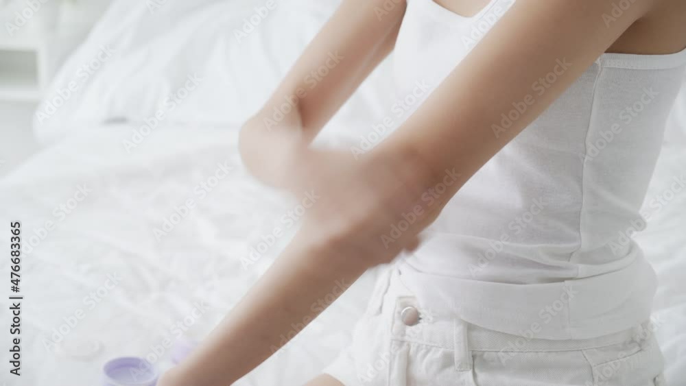 Beautiful young asian woman happy applying cream or lotion with moisturizer to skin on arm, beauty asia girl applying skincare with cosmetic makeup for hygiene and wrinkle, skin care concept. Beautiful young asian woman happy applying cream or lotion with moisturizer to skin on arm, beauty asia girl applying skincare with cosmetic makeup for hygiene and wrinkle, skin care concept.