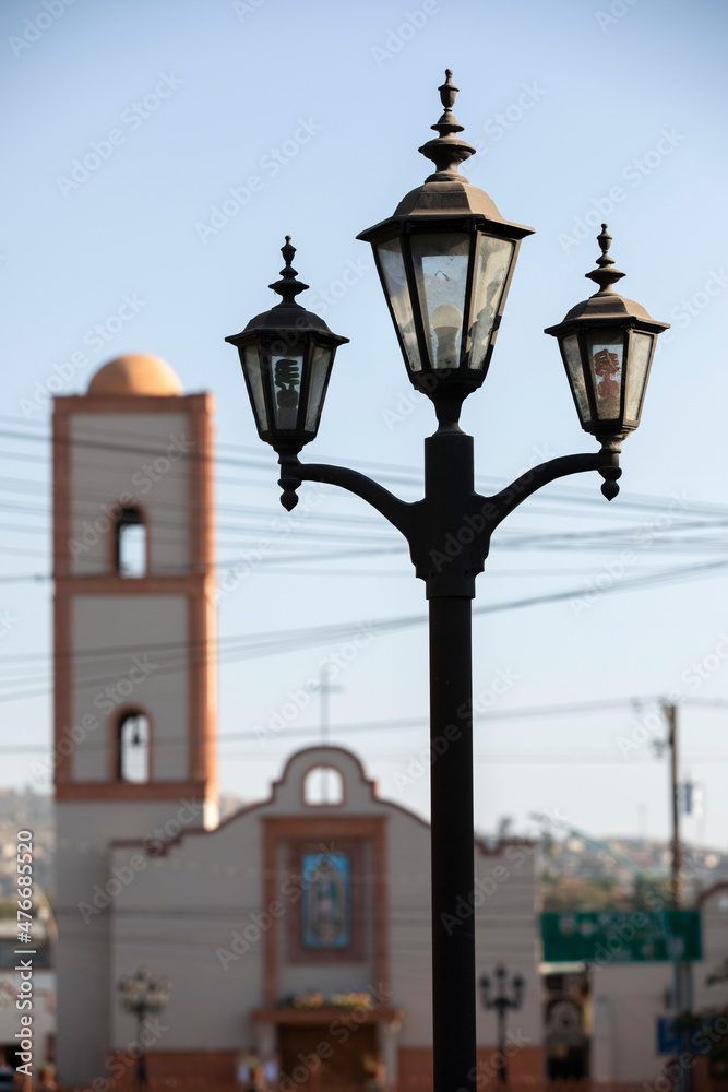 Tecate, Baja California, Mexico - September 14, 2021: Late afternoon light shines on historic downtown street lights.