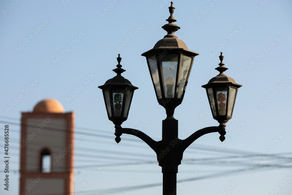 Tecate, Baja California, Mexico - September 14, 2021: Late afternoon light shines on historic downtown street lights.
