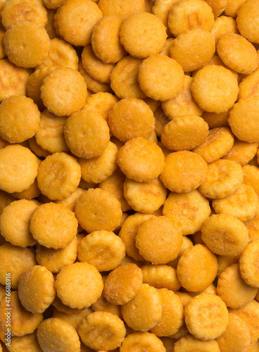 cheese biscuits background  crispy and crunchy round shape crackers  tea time snack taken from above  closeup